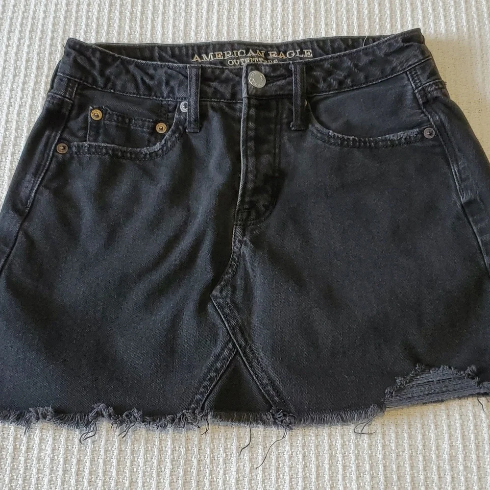 American Eagle Outfitters black washed  denim  mini skirt Size 0 with raw hem
